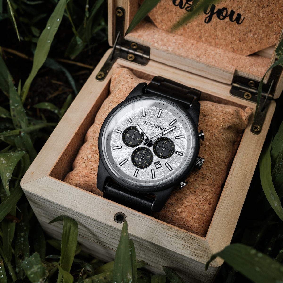 "Northwall" watch in natural wood-tone box, featuring a sleek silver and black design.