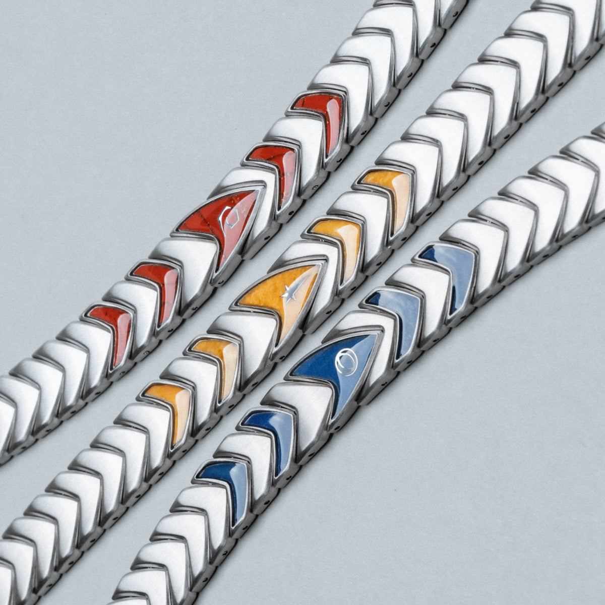 "Command" bracelet featuring a sleek, silver chevron design with vivid jade accents.