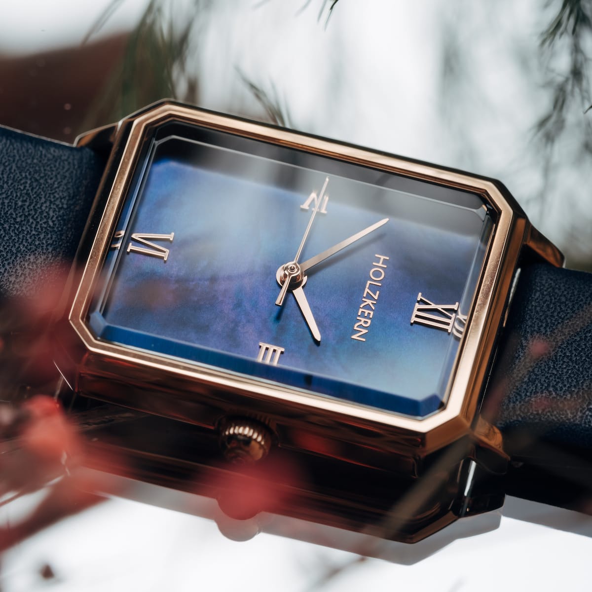 "Sapientia", a stylish watch with a nacre face and rose gold accents, features a sleek rectangular design.