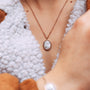"Mirror Necklace": a stylish necklace with a turquoise center set in rose gold, offering an elegant and modern look.