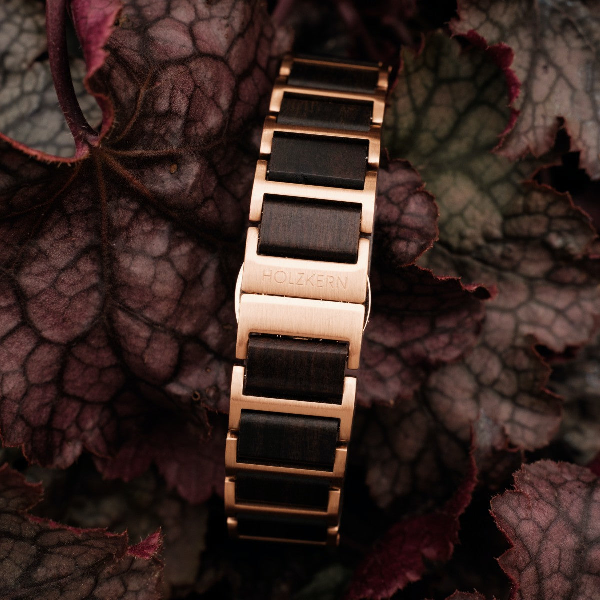 "Maui" watch with a maple and nacre finish, featuring a stylish, natural design among vibrant leaves.
