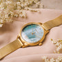 Orologio "Talamanca" con quadrante nacre e fascia in rete oro, design elegante e sofisticato.
