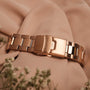 "The Passionate, elegant watch with rose gold accents and nacre finish on soft fabric."