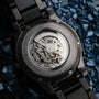 "Pacemaker, a watch with a marble design, showcases its intricate mechanical movement against a textured background."