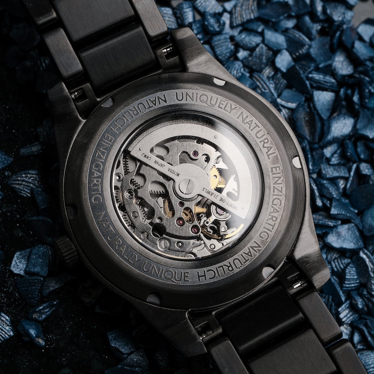 "Pacemaker, a watch with a marble design, showcases its intricate mechanical movement against a textured background."