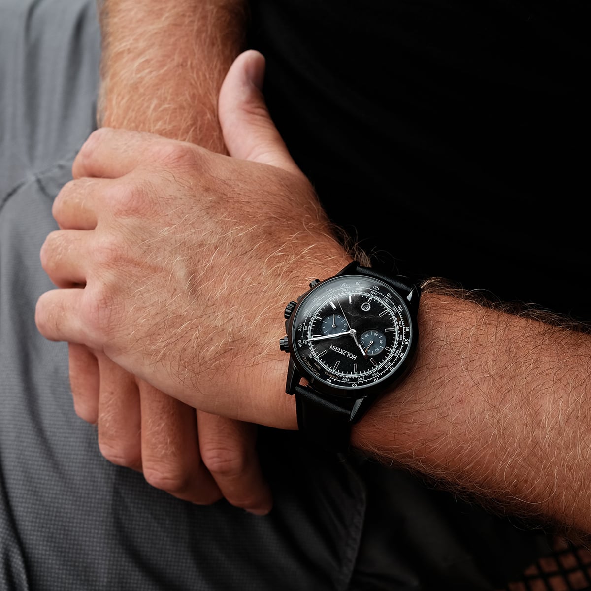 "Rackets watch featuring a sleek black design on a wrist."