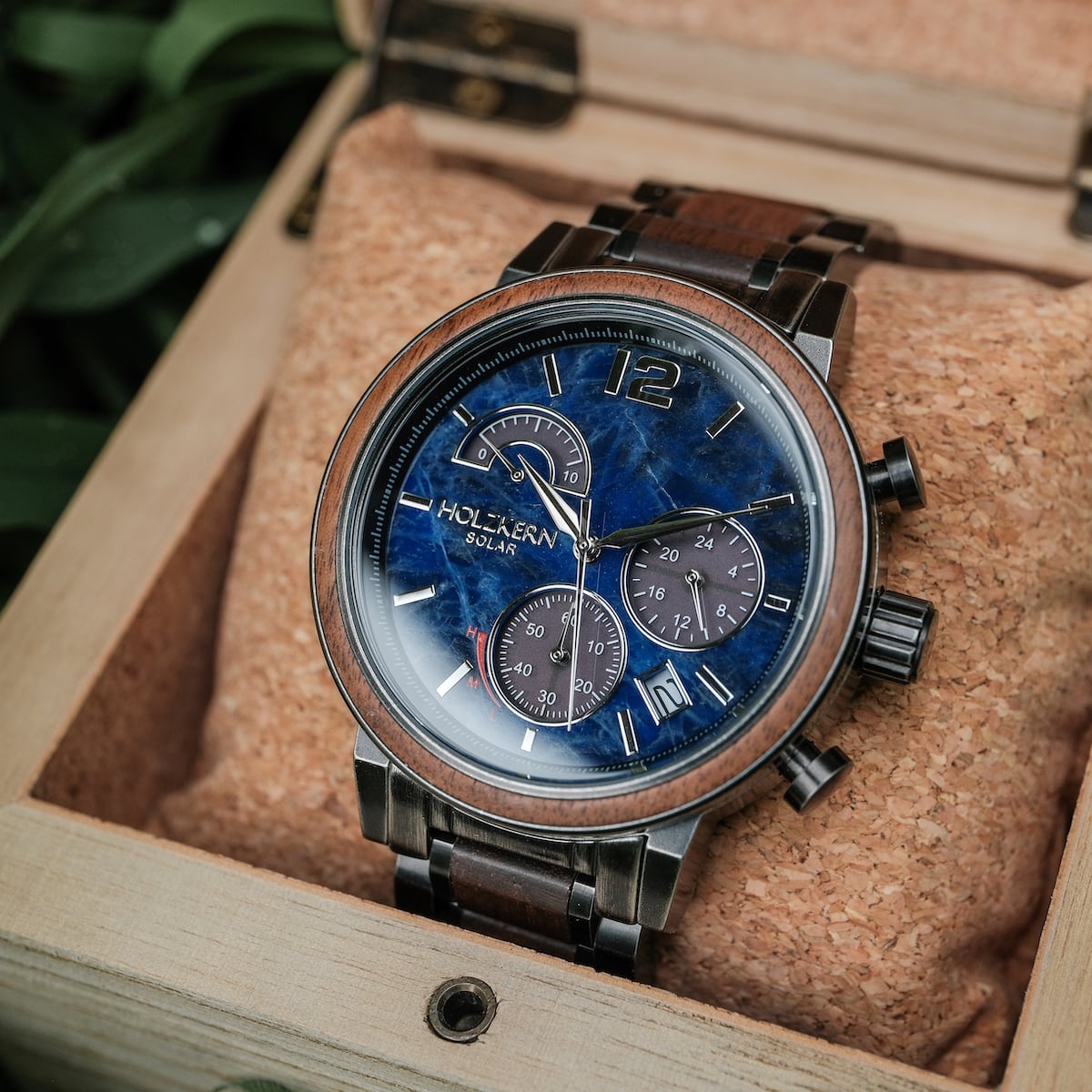 "Syntonize" watch featuring a sodalite dial with walnut accents in a sleek, modern style, displayed in a wooden box.