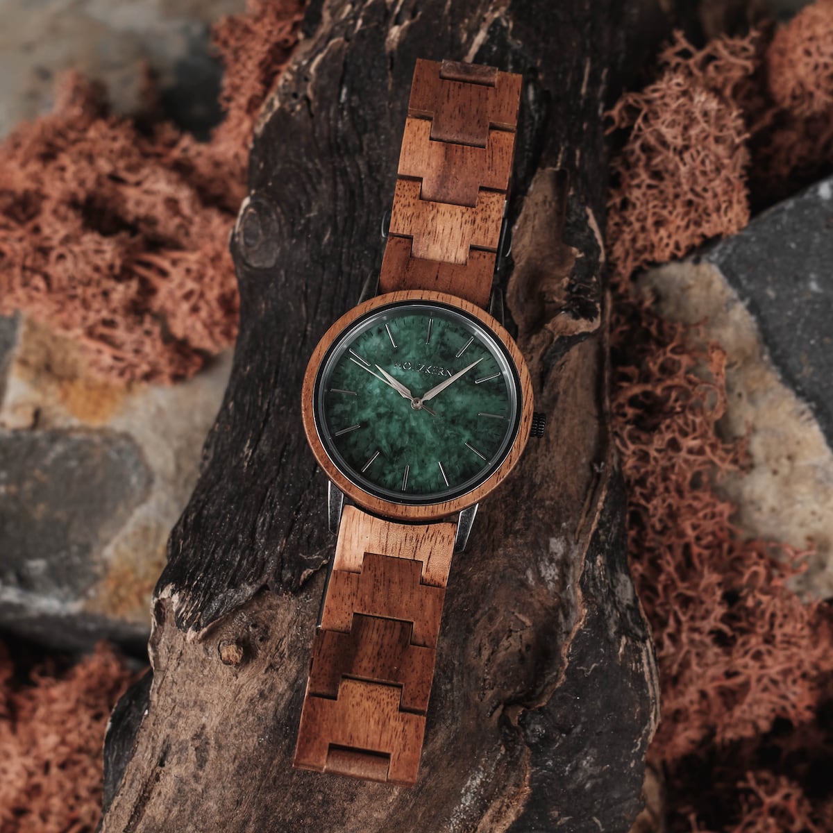 "Bob", a stylish wooden watch featuring koa and marble materials, lies on a rustic background.