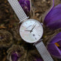 "Piccolo" watch with nacre dial and silver mesh band, elegant and sophisticated style.