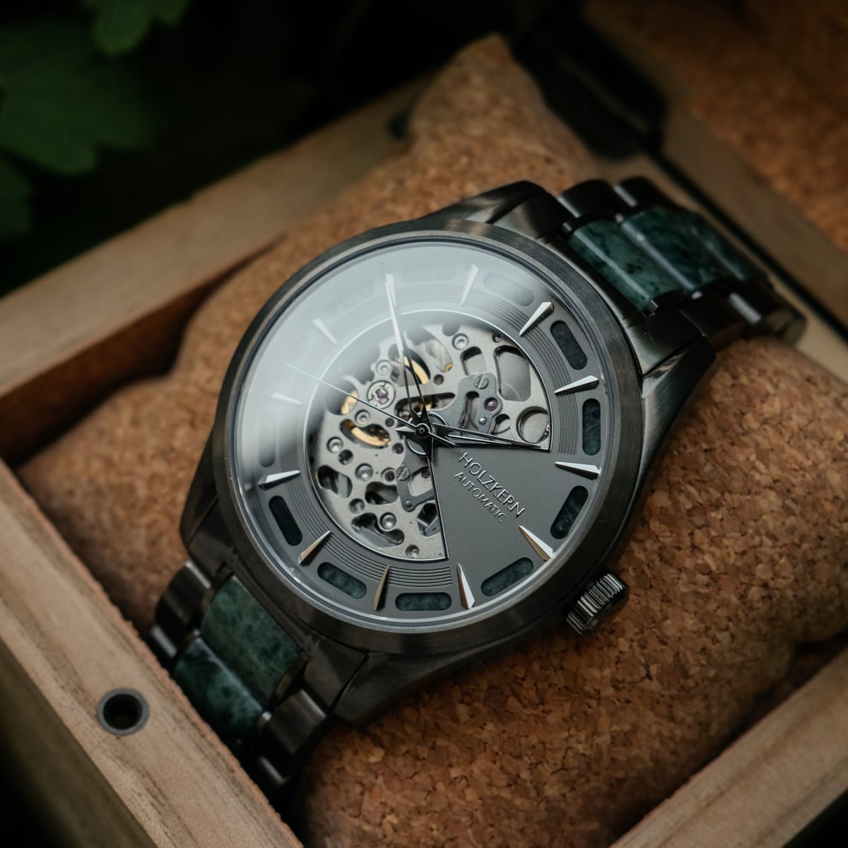 "Acraman" watch featuring a sophisticated marble and dark grey design with a visible mechanism in a wooden box.