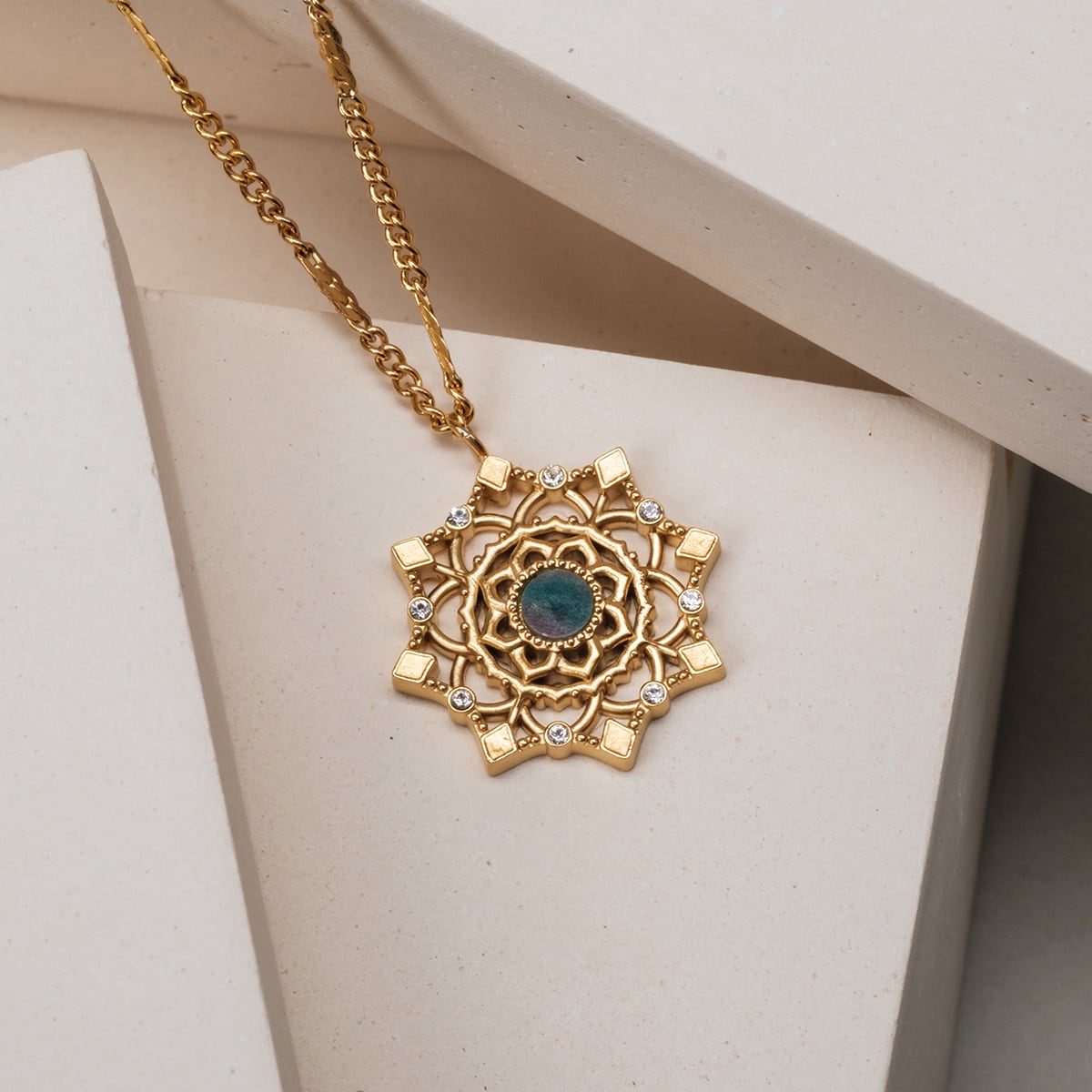 "Aphonia Necklace" necklace featuring a gold design and green marble accents.