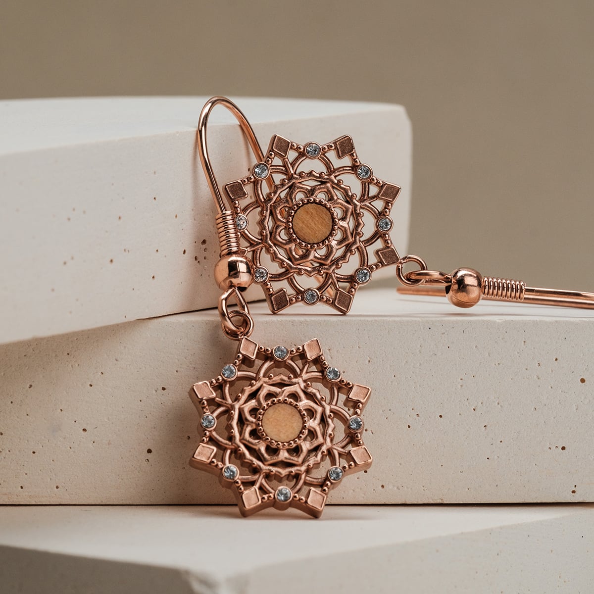 "Aphonia Earrings" earrings, featuring an ornate design in rose gold with olive accents.