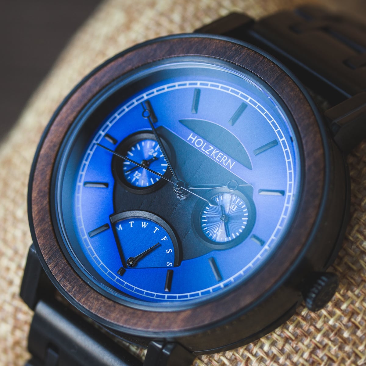 "Belize" watch featuring a leadwood case and vibrant blue dial with intricate details.