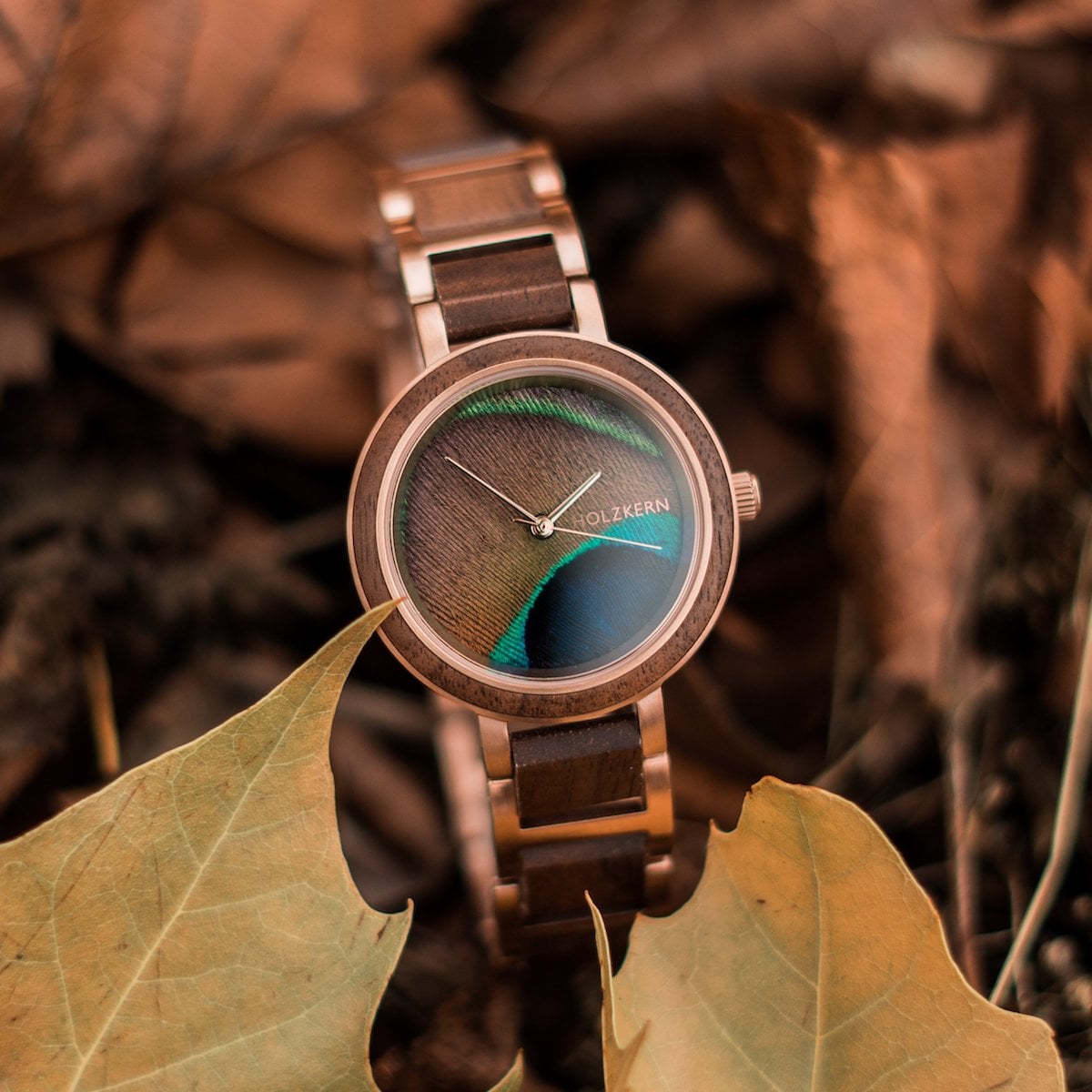 "The Optimist" watch featuring a walnut and peacock feather design with a natural, earthy aesthetic.