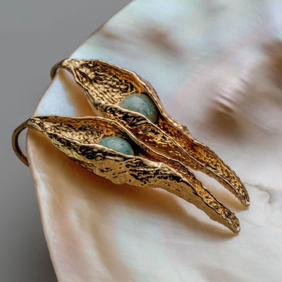 "Chalice Earrings": elegant gold earrings with textured design and Amazonite accents.