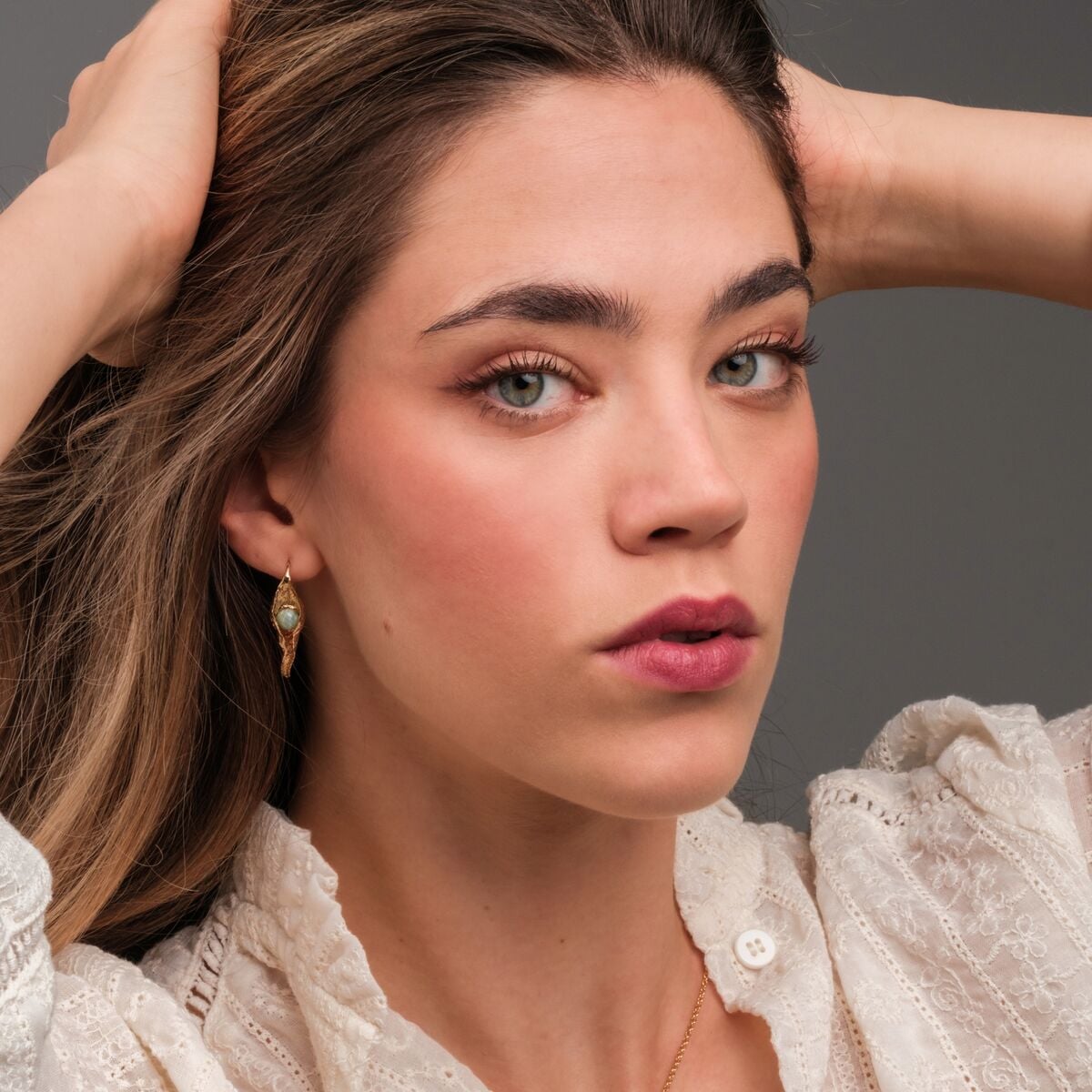 "Chalice Earrings" earrings, featuring a delicate amazonite stone set in gold, exude elegance and charm.
