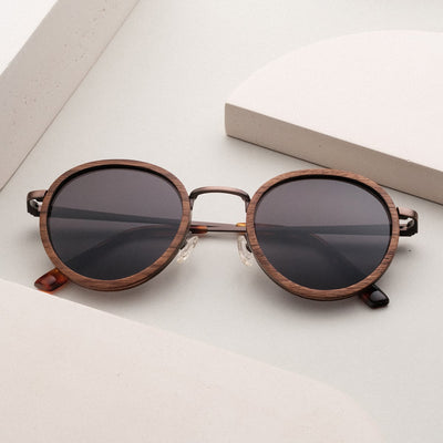 "The Radiant S", stylish sunglasses with a walnut and copper finish featuring round lenses and a minimalist design.