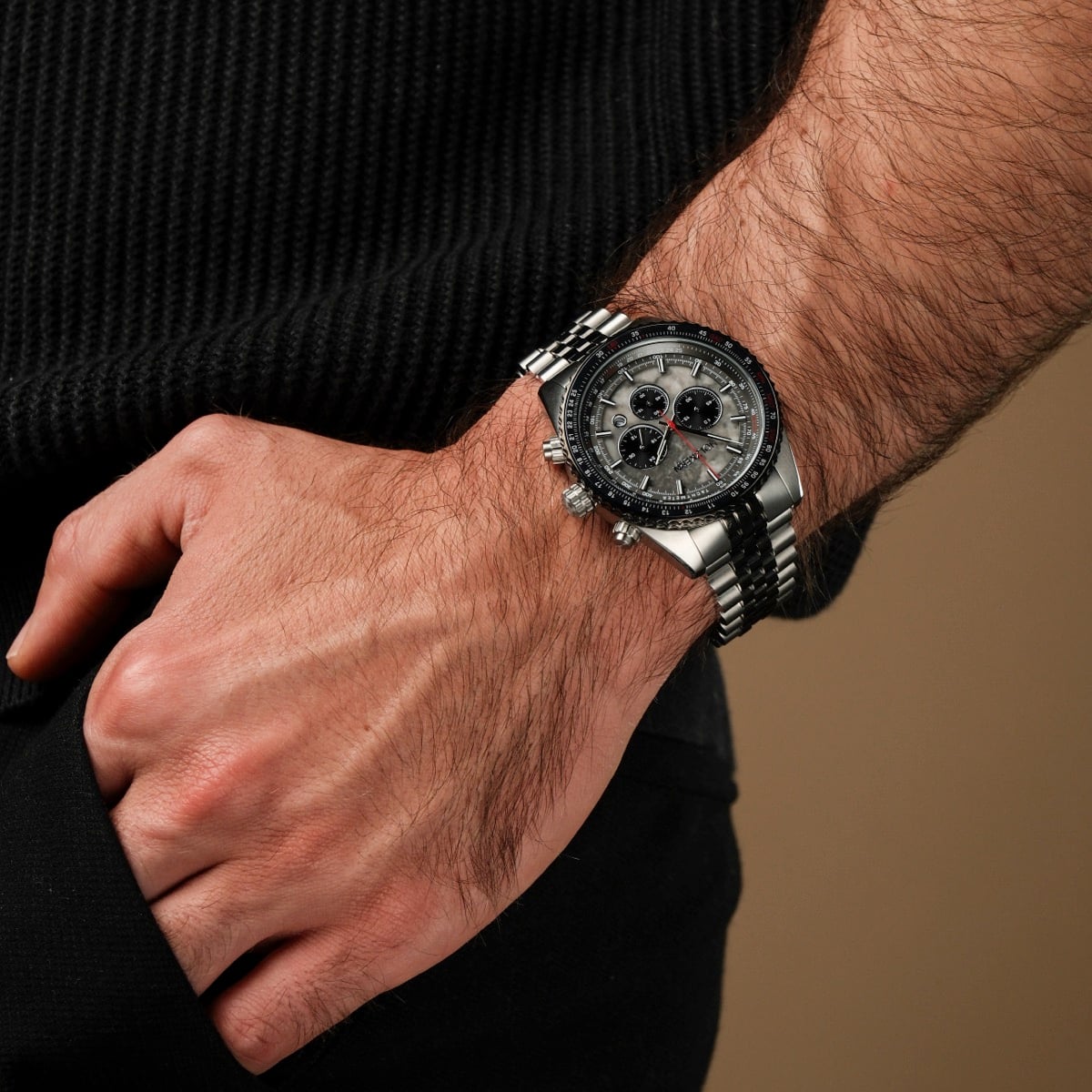 L'orologio "Openhorizon" presenta un volto in marmo grigio e un design argentato, indossato al polso.