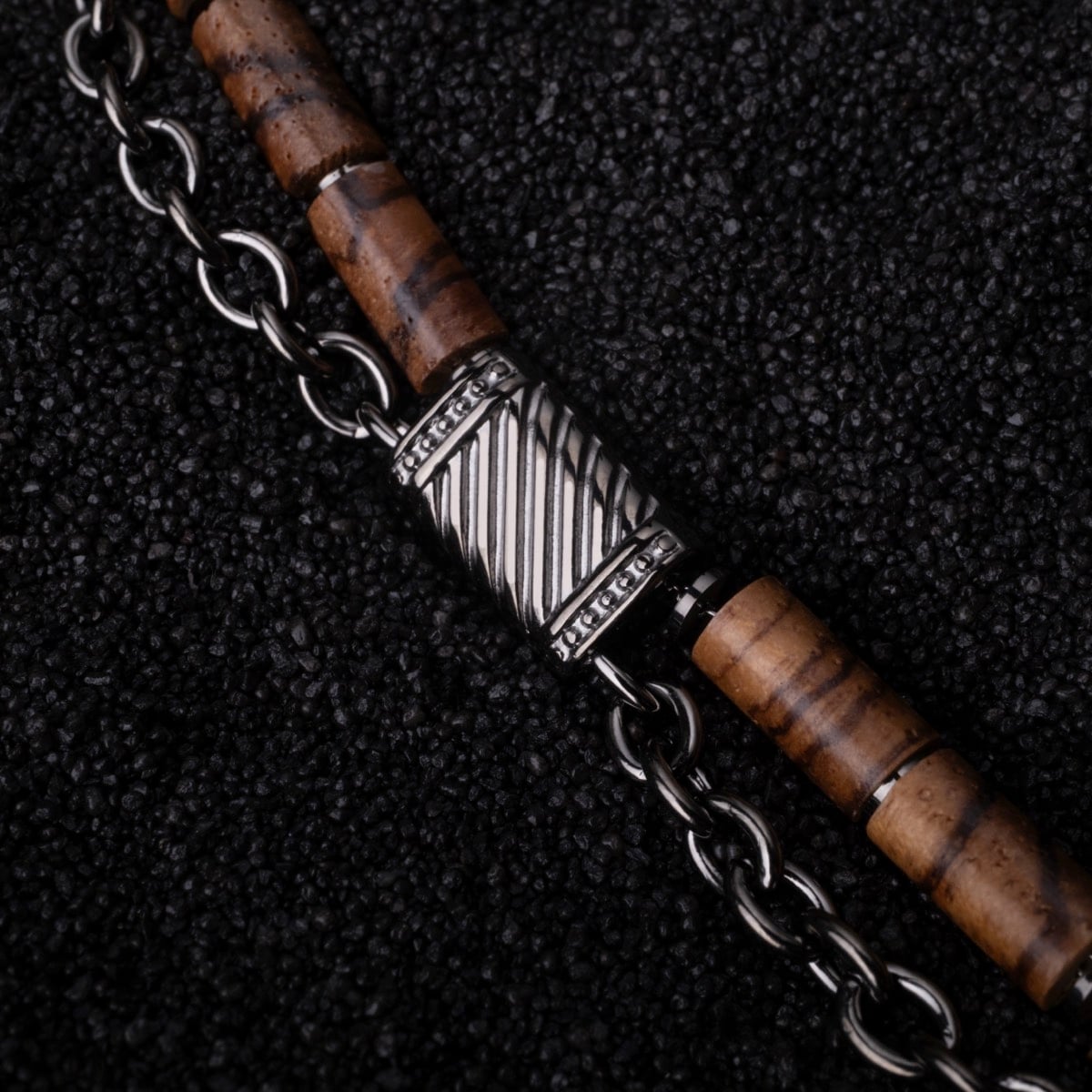 "Supersonic" bracelet featuring zebrawood and gray chain with intricate detailing.