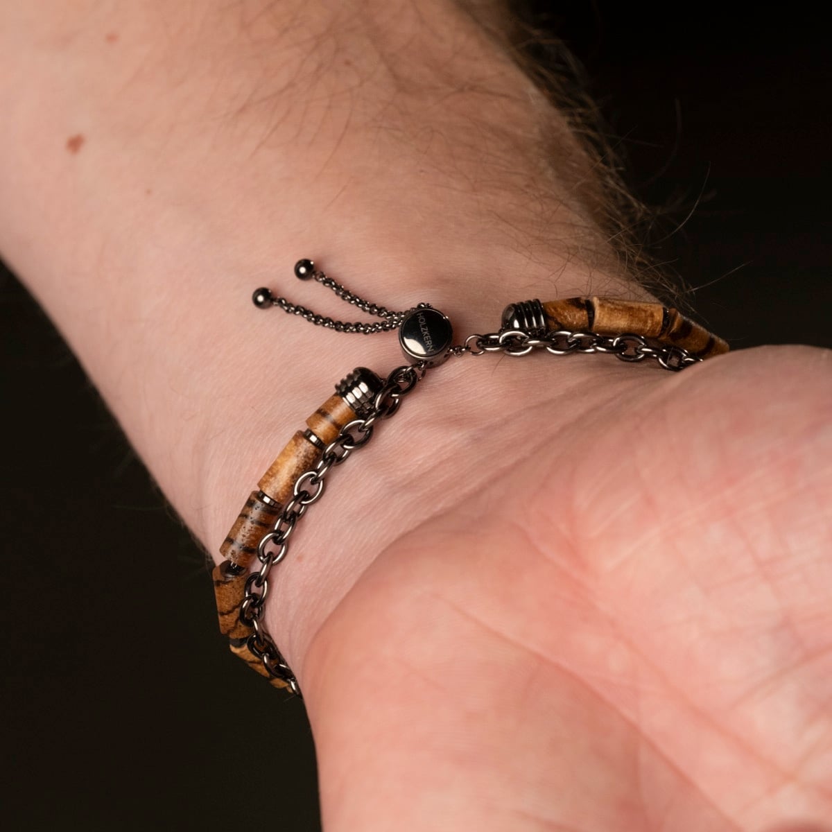 "Supersonic" bracelet features zebrawood beads and gray chain accents for a sleek, stylish look.