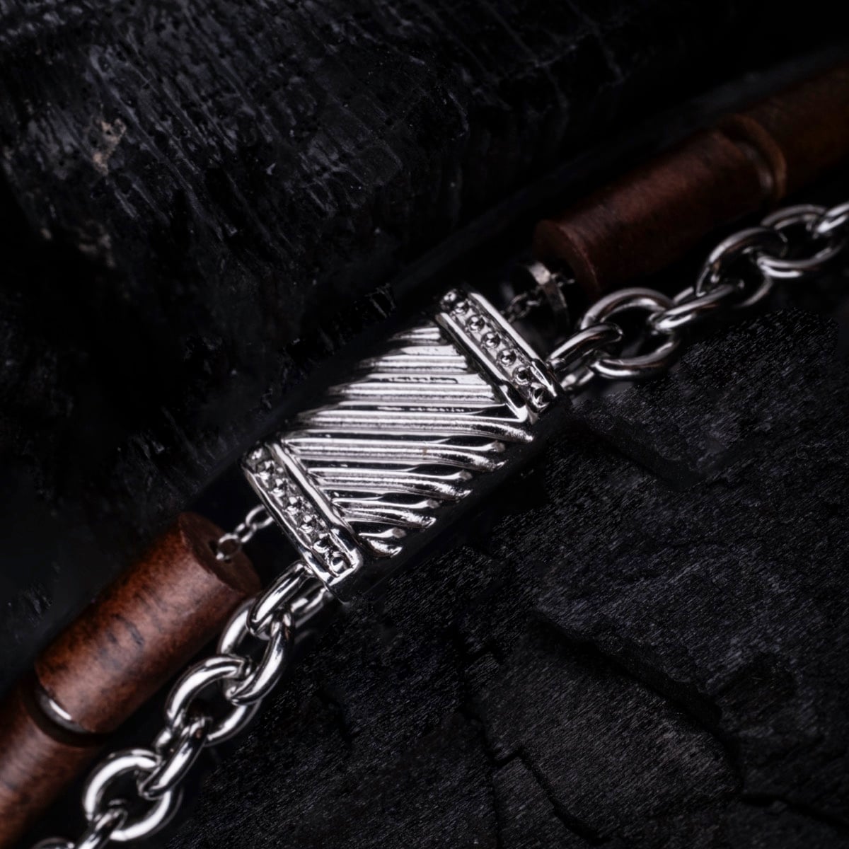 "Supersonic" bracelet featuring walnut wood and silver accents in a sleek, modern design.