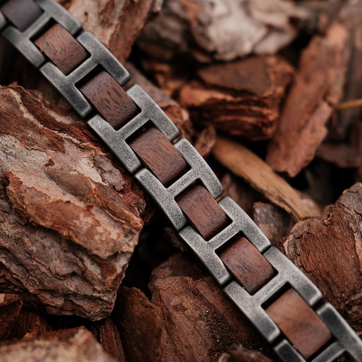 "Acoustic" watch strap featuring walnut wood and antique silver accents in a natural, rustic style.