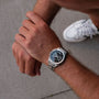 "Norium watch with marble and silver design worn on wrist, featuring a sleek, modern look."