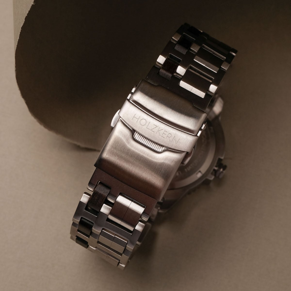 "Norium, a watch featuring a sleek marble and silver design with an elegant metal clasp."