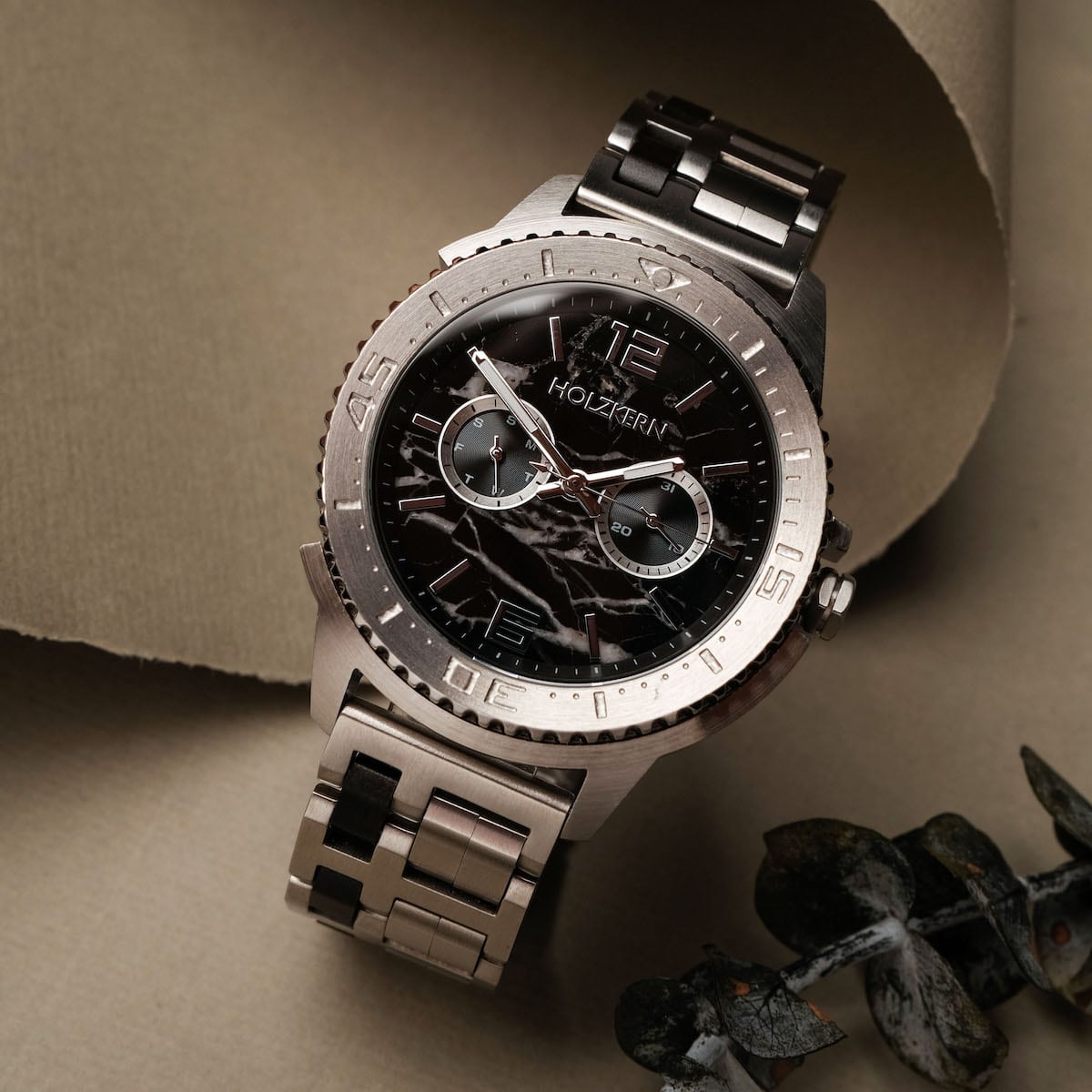 "Norium watch with a marble dial and silver-toned metal band, featuring a sleek, modern design."