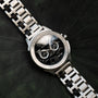"Norium watch featuring a marble-patterned dial and silver band, combining elegance and modern style."