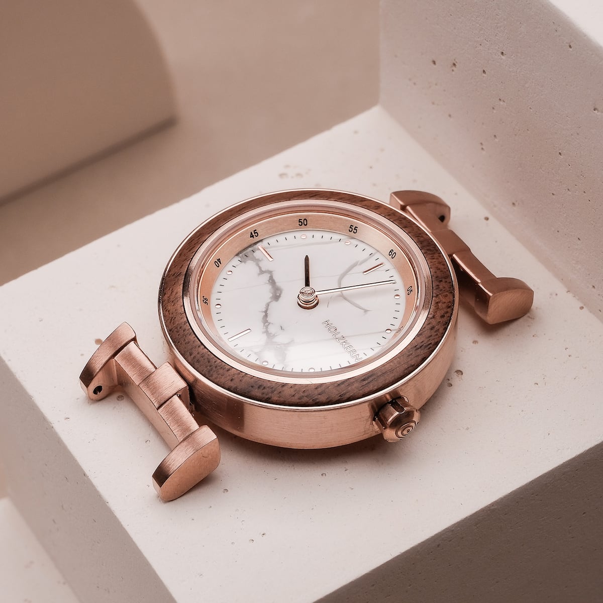 "Ida" watch featuring a walnut and marble design with rose gold accents.