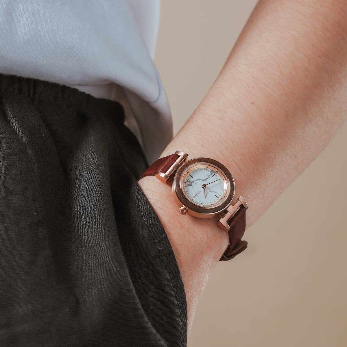 "Ida" watch featuring a classic walnut and marble design on a wrist.