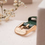 "Laura", a stylish belt with a green leather strap and gold buckle, exuding elegance and sophistication.