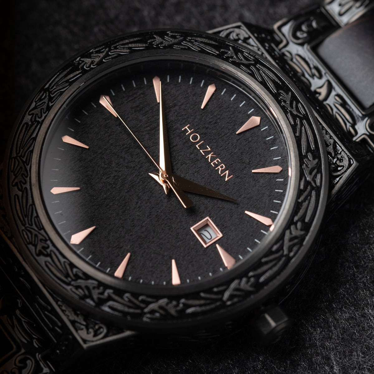 "Khalili" watch with intricate black detailing and rose gold accents.