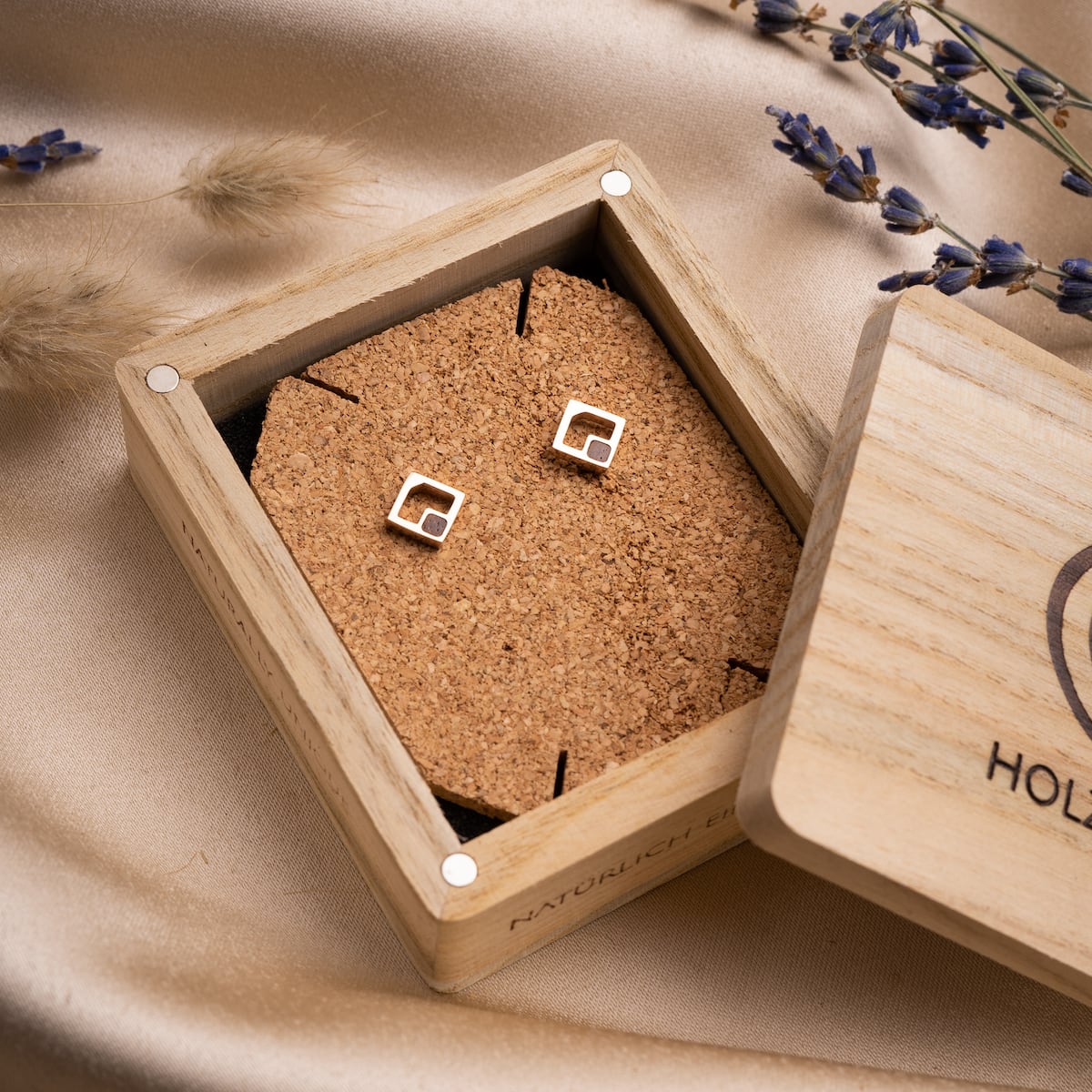 "Geometric Earrings" earrings, featuring a geometric design in walnut and rose gold, displayed in an elegant wooden box.